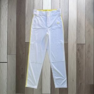 Nike men’s white baseball pants with yellow accents.